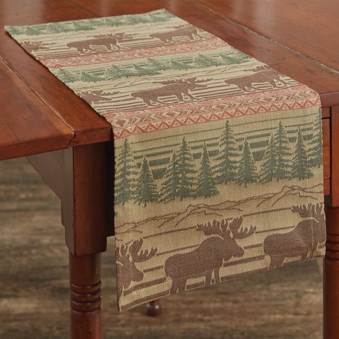 The Moose Jacquard Table Runner offer a beautiful outdoorsy appeal! Featuring a blend of neutral colors and a pop of red that work together to create a breathtaking scene of moose in their natural habitat, this table runner is sure to bring the rugged outdoors in! Coordinate with the complementary Moose Jacquard kitchen linens and curtains to complete the look! Available in two sizes (sold separately).
