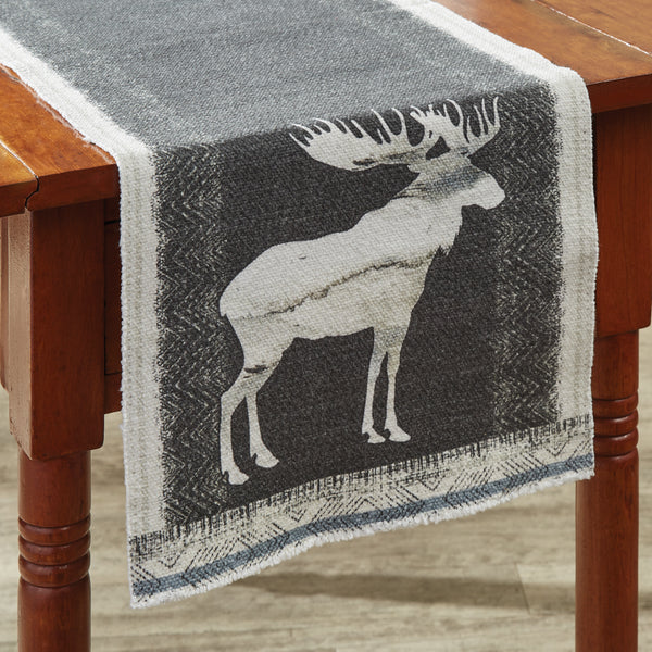The Into The Woods Moose Table Runner offer a beautiful outdoorsy appeal! Featuring a white moose silhouette on a charcoal background, this table runner is sure to bring the rugged outdoors in! 