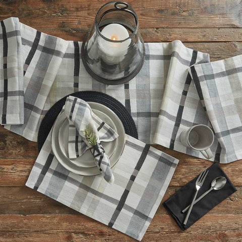 Enhance your dining experience with this country charming Urban Plaid Table Runner! Soft tones of white, gray & tan blend together to create a pretty plaid that oozes warmth & style! Decorate your table in style!! Add to this classic look with the Urban Plaid napkins and placemats!