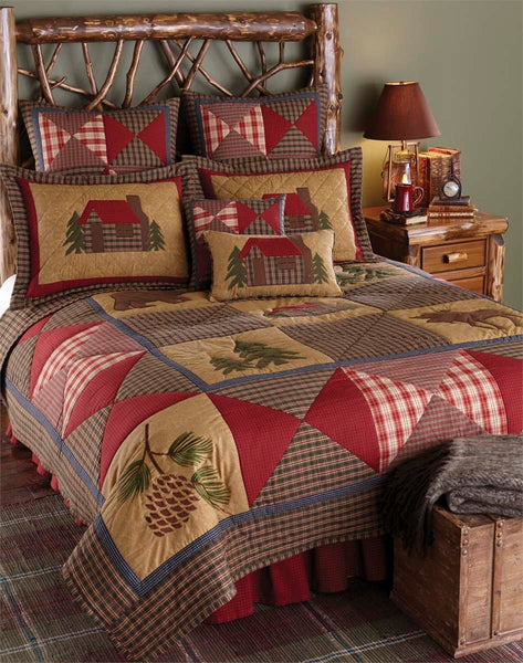 Cabin Patchwork Euro Sham displays a patchwork image of a quaint log cabin in tan, red, green, and blue.