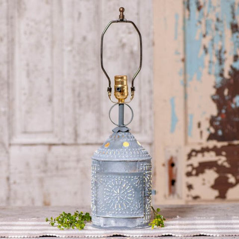 Paul Revere lamp is a staple in country living and rustic farmhouse decor. This weathered grey zinc base is decorated with layers of stamped metal that shine like geometric starbursts. Use the three-way switch to control the bulb on top and cast a warm glow through base. The base, which does not include a shade, is ready for you to add the 15-Inch decorator shade of your choice.
