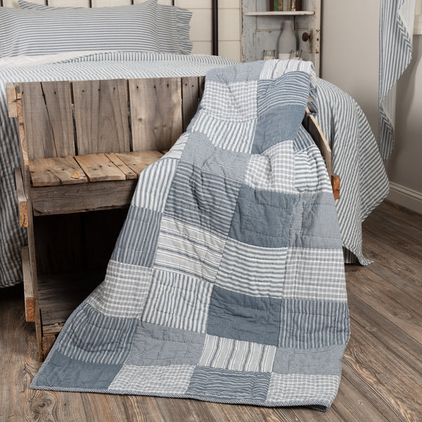 Sawyer Mill Blue Block Quilted Throw 60x50, Featuring simple block layout in various plaid and striped farmhouse fabrics with stitch in the ditch and echo hand quilting on denim blue and soft white fabrics. Primitive Country Farmhouse Bedding Blanket Home Decor.
